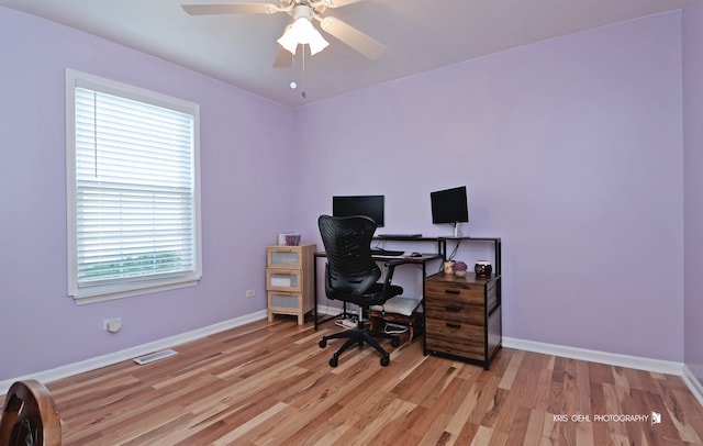 office with light hardwood / wood-style floors and ceiling fan