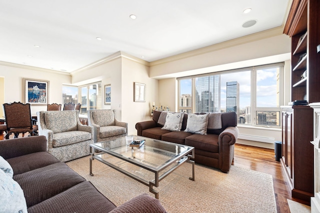 living room with ornamental molding and light hardwood / wood-style flooring