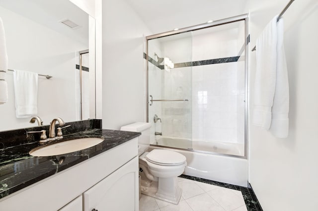 full bathroom featuring tile patterned floors, shower / bath combination with glass door, toilet, and vanity