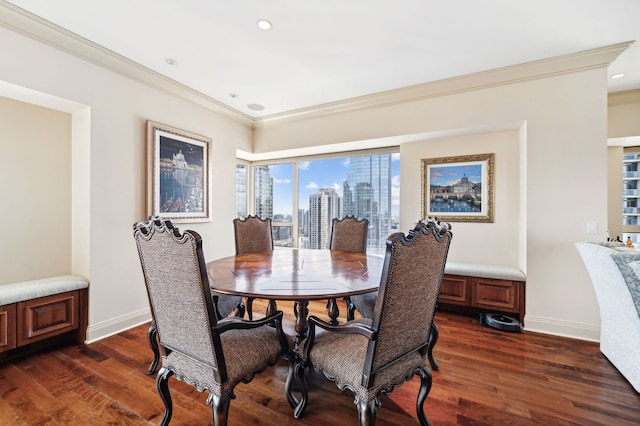 dining room featuring ornamental molding and dark hardwood / wood-style flooring