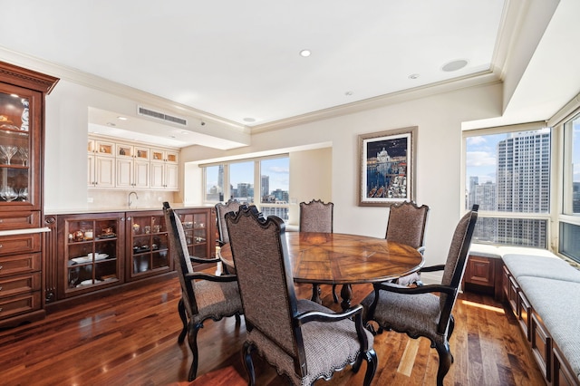 dining room with crown molding, a wealth of natural light, and dark hardwood / wood-style floors