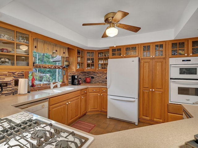 kitchen featuring ceiling fan, light tile patterned floors, backsplash, white appliances, and sink