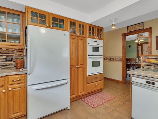 kitchen featuring decorative backsplash, light tile patterned floors, white appliances, and ceiling fan