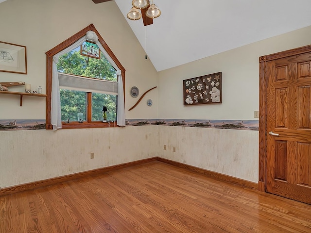 unfurnished room featuring light hardwood / wood-style flooring and lofted ceiling