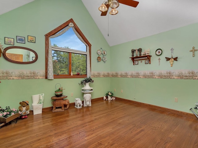 interior space with ceiling fan, high vaulted ceiling, and wood-type flooring