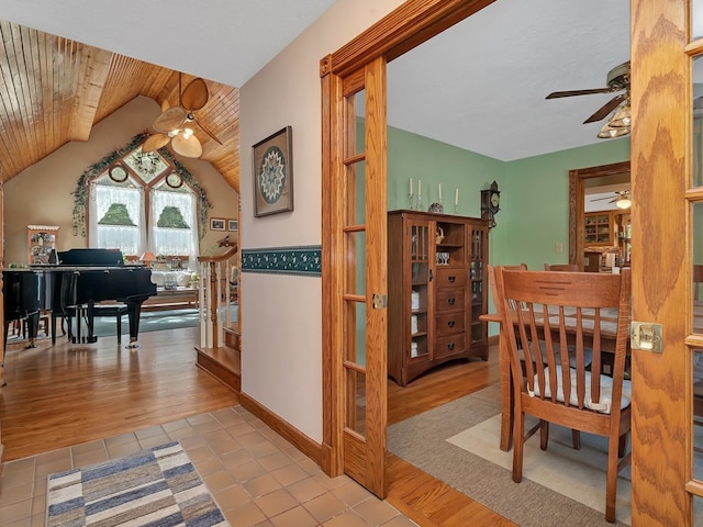 interior space with vaulted ceiling, light tile patterned floors, and wooden ceiling