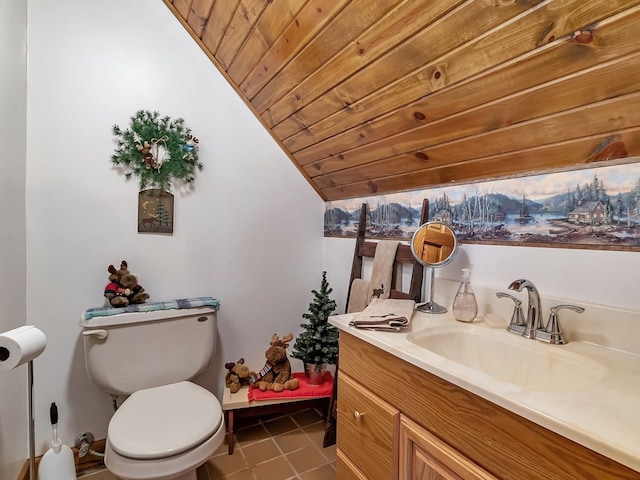 bathroom featuring lofted ceiling, wood ceiling, toilet, tile patterned flooring, and vanity