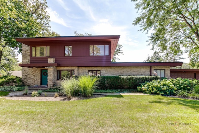 contemporary home with a front lawn