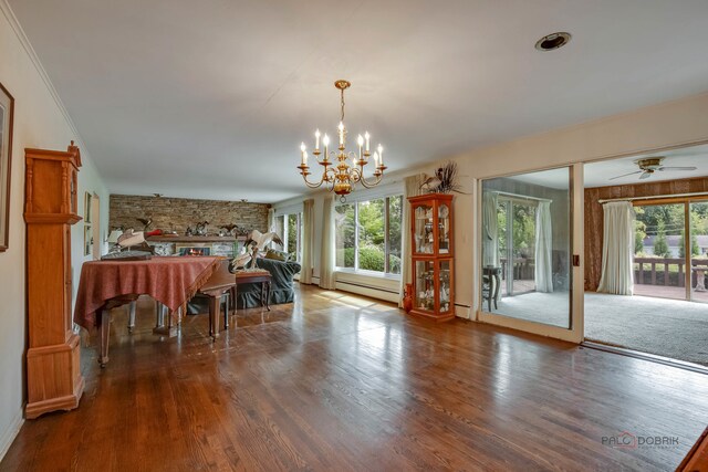 dining room featuring a baseboard heating unit, ceiling fan with notable chandelier, and hardwood / wood-style floors