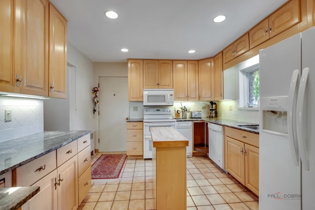 kitchen with light brown cabinets, backsplash, white appliances, and light tile patterned floors