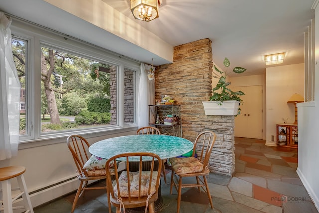 dining space with tile patterned flooring, a baseboard radiator, a healthy amount of sunlight, and a chandelier