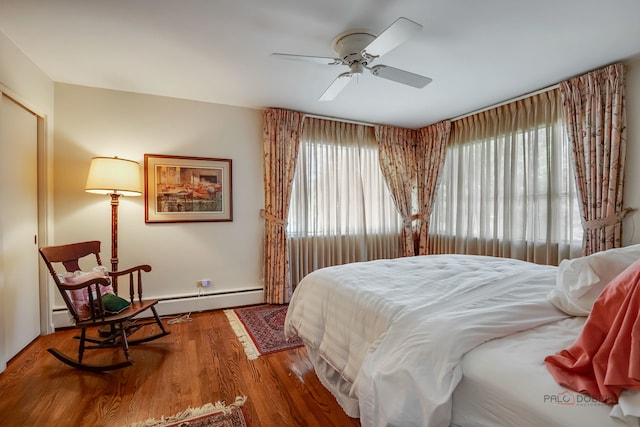 bedroom featuring hardwood / wood-style floors, ceiling fan, and multiple windows