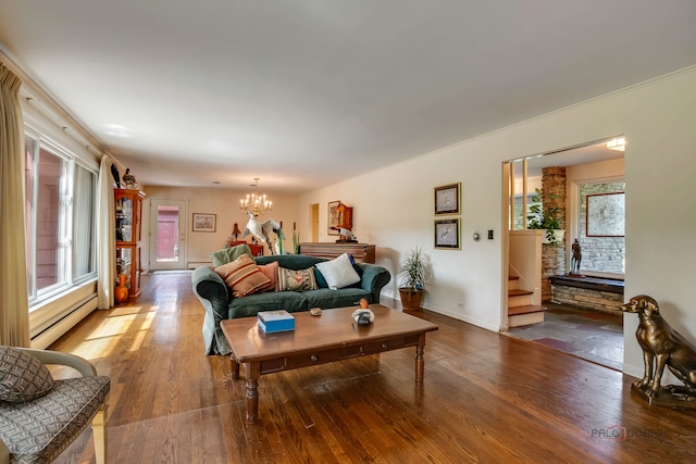 living room featuring an inviting chandelier, a baseboard radiator, and wood-type flooring