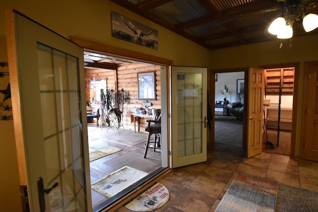 doorway with tile patterned floors and a ceiling fan