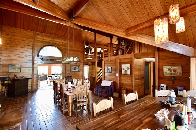 dining area with high vaulted ceiling, wooden walls, wood ceiling, and beam ceiling