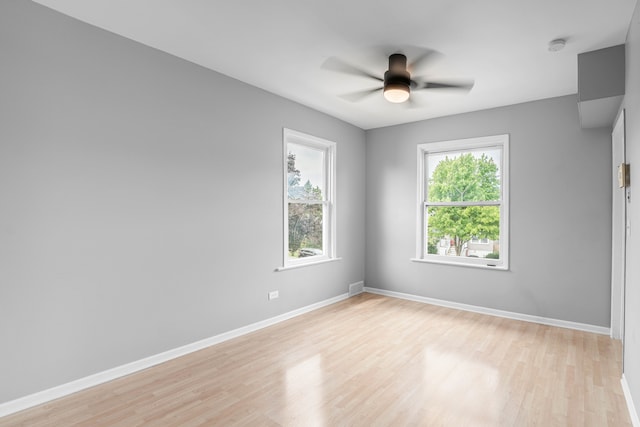 unfurnished room with light wood-type flooring and ceiling fan