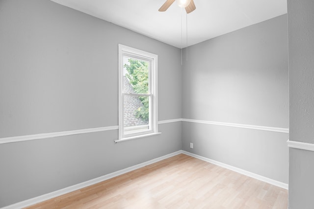 spare room featuring hardwood / wood-style floors and ceiling fan