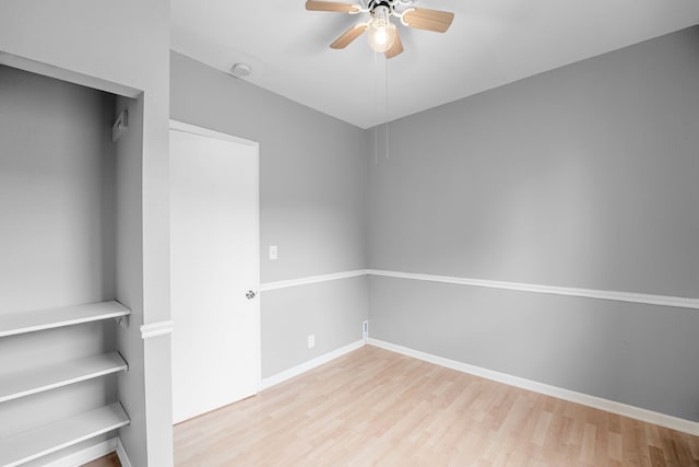 empty room with ceiling fan and wood-type flooring