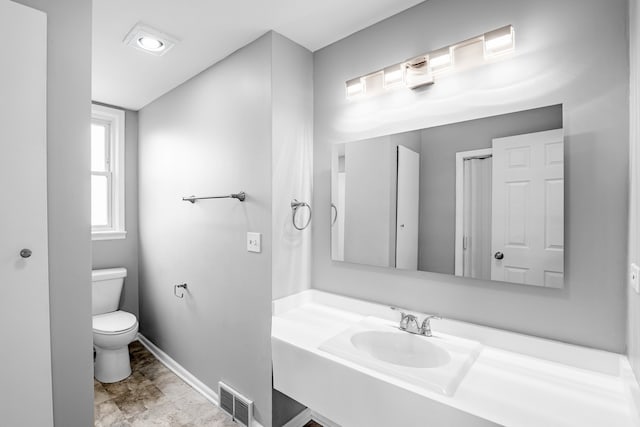 bathroom with vanity, toilet, and tile patterned flooring