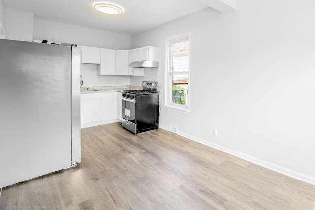 kitchen with white cabinets, white refrigerator, light wood-type flooring, and gas range