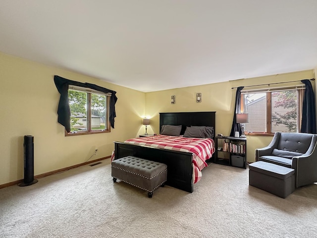 bedroom with visible vents, carpet flooring, and baseboards