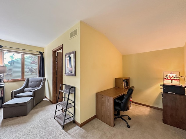 carpeted office space with visible vents, baseboards, and lofted ceiling