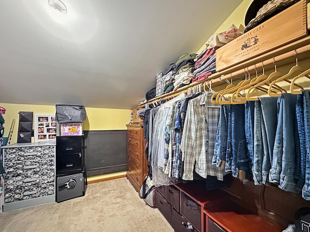 walk in closet featuring lofted ceiling and carpet floors