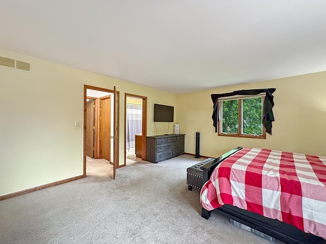 carpeted bedroom featuring visible vents and baseboards