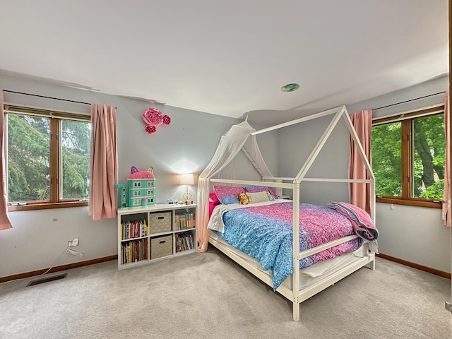 carpeted bedroom featuring visible vents and baseboards