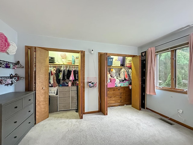 carpeted bedroom with baseboards and visible vents