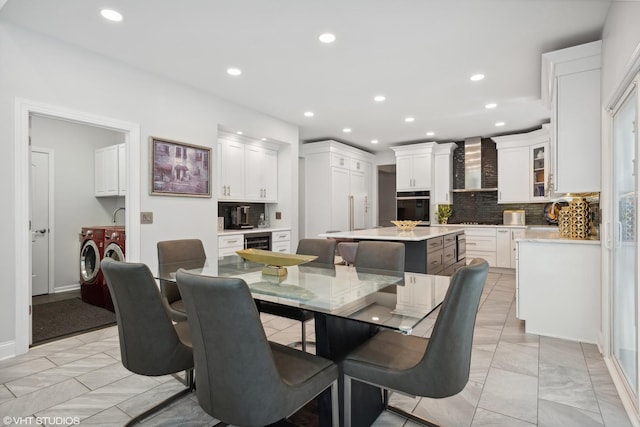 dining room featuring separate washer and dryer and sink