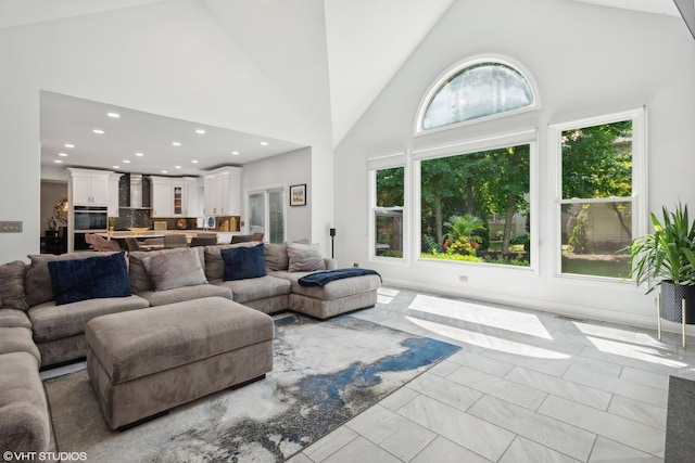 living room with high vaulted ceiling