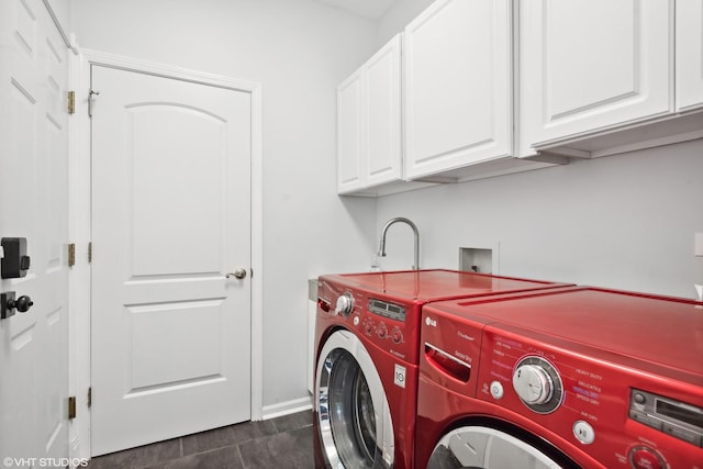 washroom featuring cabinets and washing machine and clothes dryer