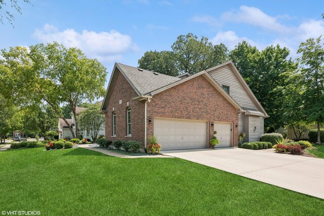 view of front of home with a front lawn and a garage