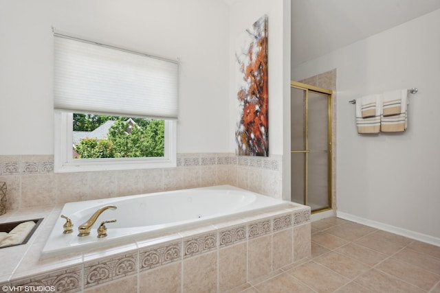 bathroom featuring tile patterned flooring and separate shower and tub