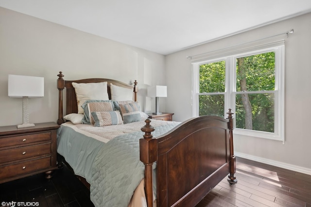 bedroom with dark hardwood / wood-style flooring