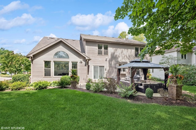 rear view of property with a yard, a gazebo, an outdoor hangout area, and a patio