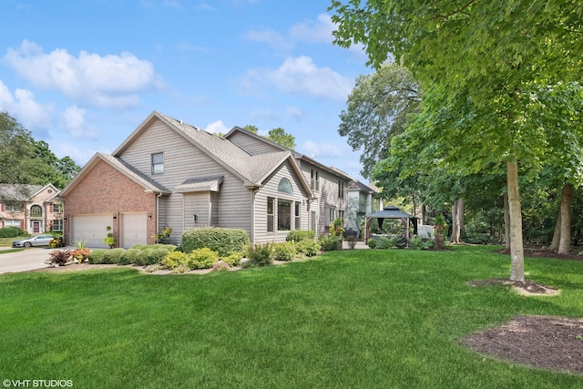 view of front facade featuring a garage, a gazebo, and a front yard