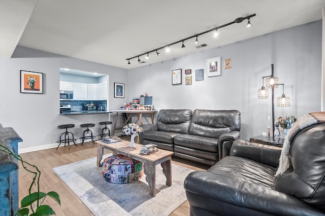 living room featuring track lighting and light wood-type flooring