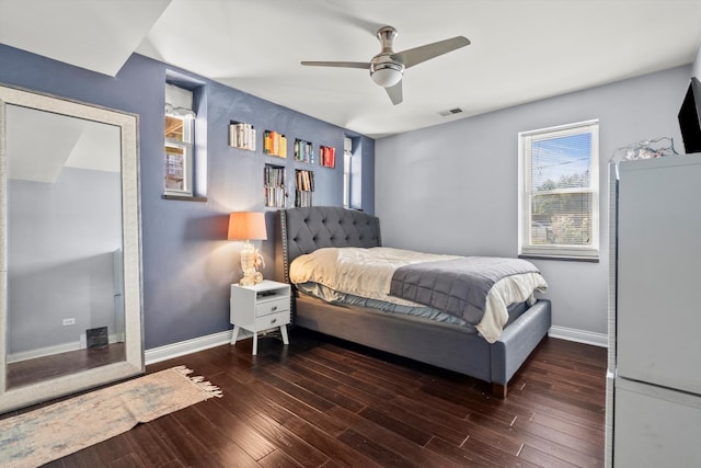 bedroom with dark hardwood / wood-style floors and ceiling fan