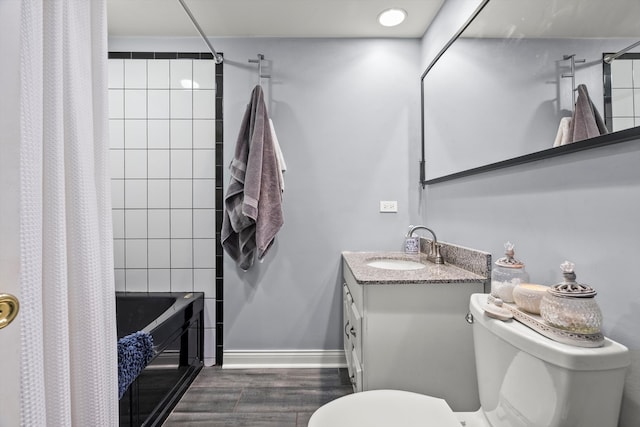 bathroom with vanity, hardwood / wood-style flooring, and toilet