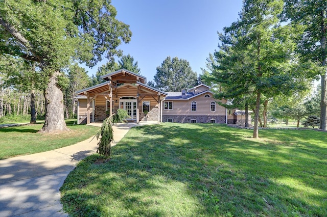 view of front facade featuring stone siding and a front lawn