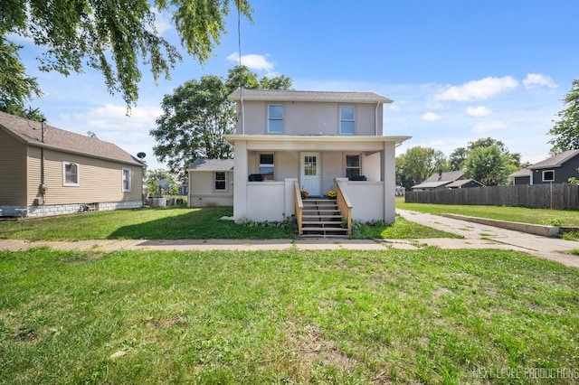 view of front of home featuring fence, a front lawn, a porch, and stucco siding