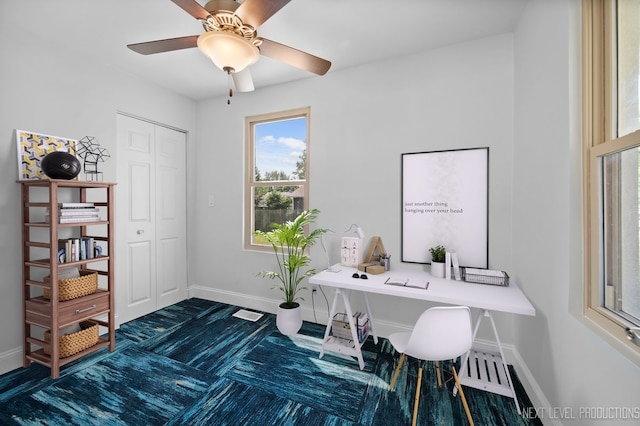 office area featuring visible vents, baseboards, and a ceiling fan