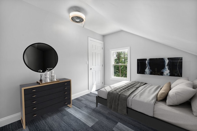 bedroom with lofted ceiling, baseboards, and dark colored carpet