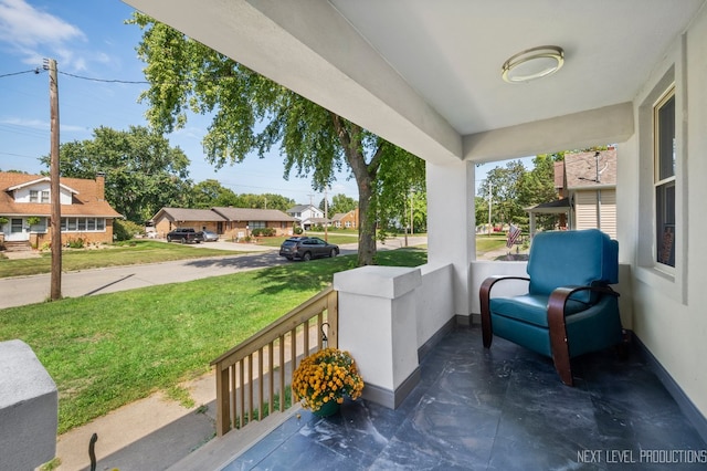 view of patio / terrace featuring a porch and a residential view