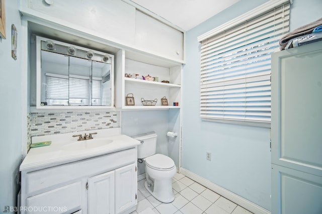 bathroom with tile patterned flooring, toilet, decorative backsplash, and vanity