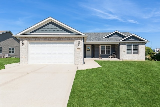 view of front of property with a garage and a front lawn