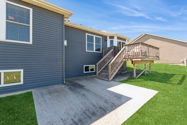 rear view of house with a lawn and a wooden deck