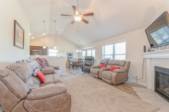 living room featuring ceiling fan and lofted ceiling